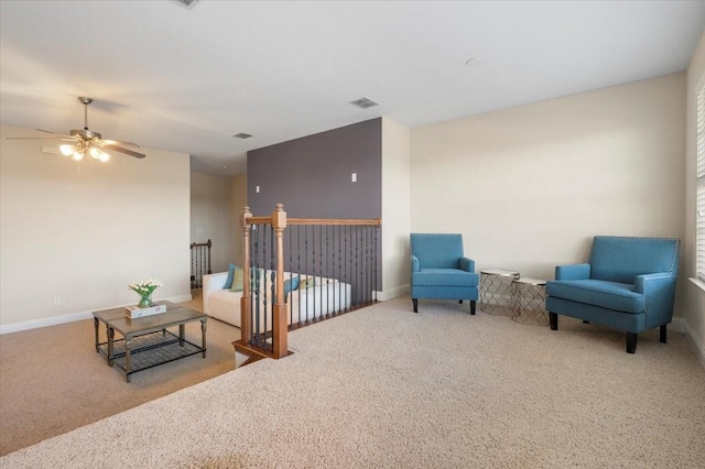 living area with ceiling fan and carpet flooring