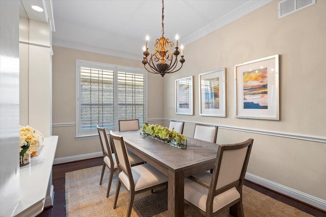 dining space with a notable chandelier, crown molding, and dark hardwood / wood-style floors