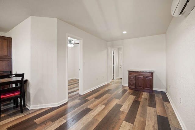 unfurnished room with dark wood-type flooring and a wall mounted AC