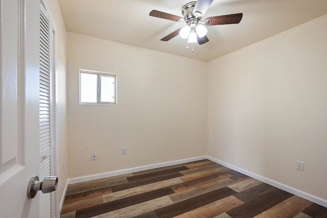 unfurnished room with ceiling fan and dark hardwood / wood-style floors