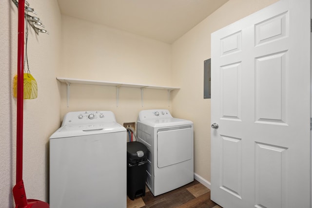 washroom with washing machine and clothes dryer, dark hardwood / wood-style floors, and electric panel