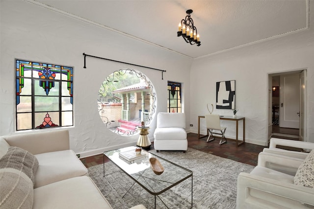 living room featuring dark hardwood / wood-style floors, a textured ceiling, and a notable chandelier