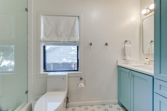 bathroom with vanity, a tile shower, and toilet