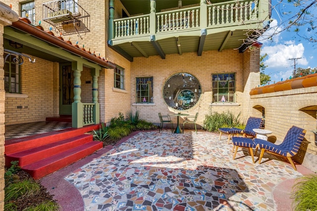 view of patio featuring a balcony