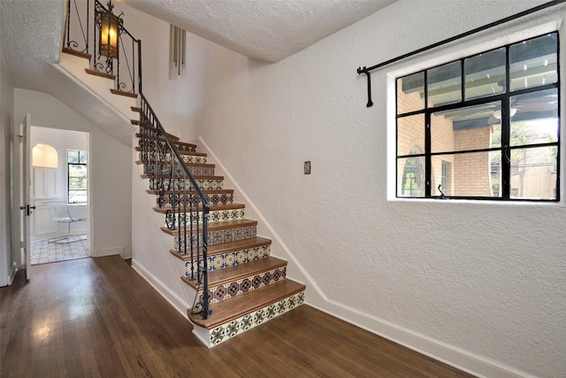 staircase featuring wood-type flooring