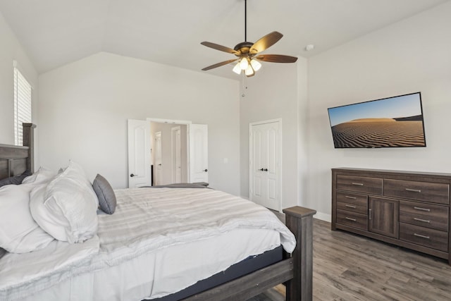 bedroom with lofted ceiling, ceiling fan, wood finished floors, and baseboards