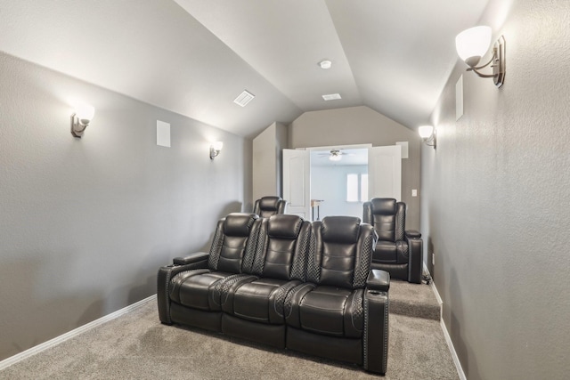 home theater with vaulted ceiling, carpet flooring, visible vents, and baseboards