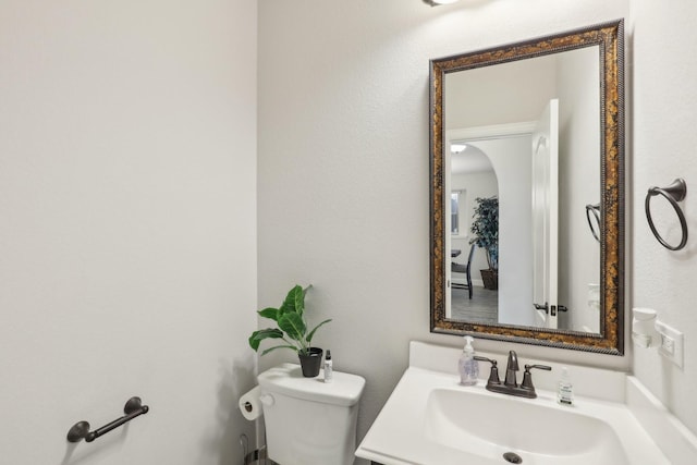 bathroom featuring toilet and vanity