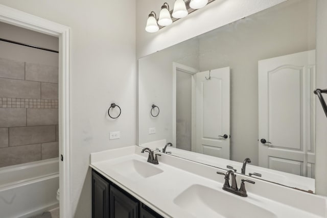 full bathroom featuring double vanity, toilet, and a sink