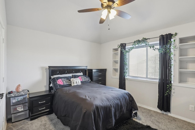 carpeted bedroom featuring vaulted ceiling, baseboards, and ceiling fan