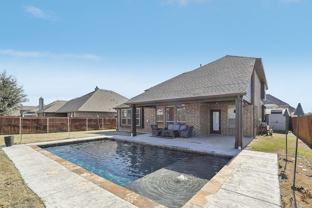 view of swimming pool with a patio, a yard, outdoor lounge area, and a fenced backyard