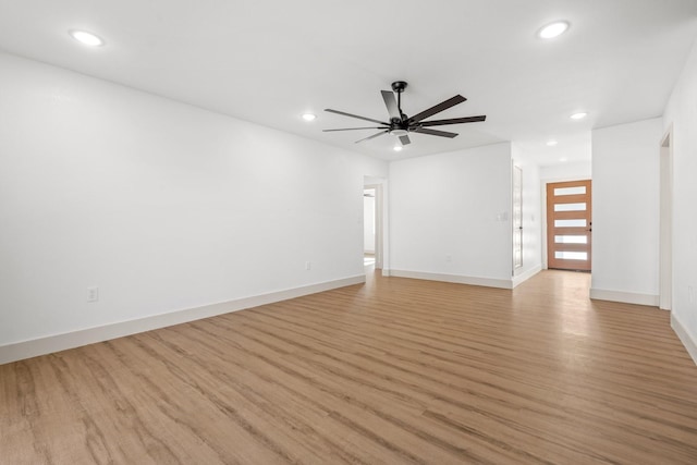 empty room featuring ceiling fan and light hardwood / wood-style flooring