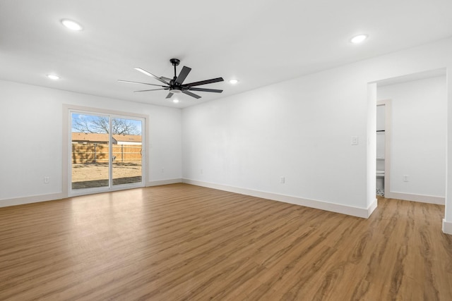 empty room featuring ceiling fan and light hardwood / wood-style floors