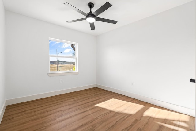 spare room with ceiling fan and hardwood / wood-style floors