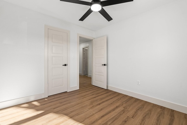 unfurnished room featuring hardwood / wood-style floors and ceiling fan