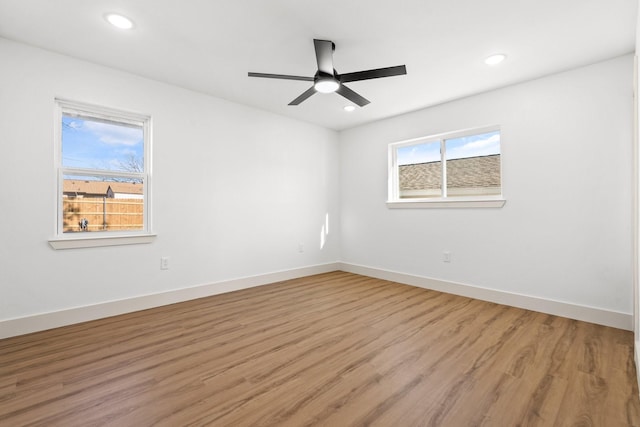 empty room with hardwood / wood-style flooring and ceiling fan