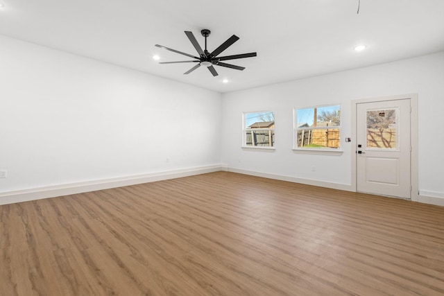 unfurnished room with ceiling fan and light hardwood / wood-style flooring