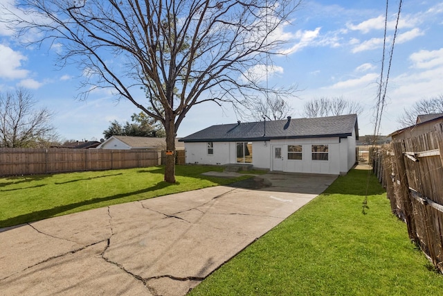 rear view of property featuring a lawn