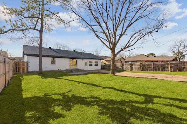 rear view of property featuring a yard and a patio area