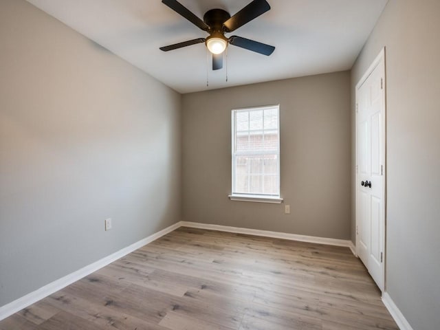 empty room with ceiling fan and light wood-type flooring