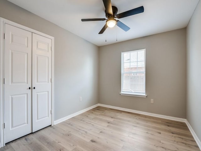 unfurnished bedroom featuring light hardwood / wood-style flooring, a closet, and ceiling fan