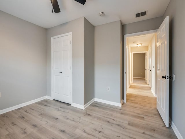 unfurnished bedroom with a closet, ceiling fan, and light hardwood / wood-style flooring