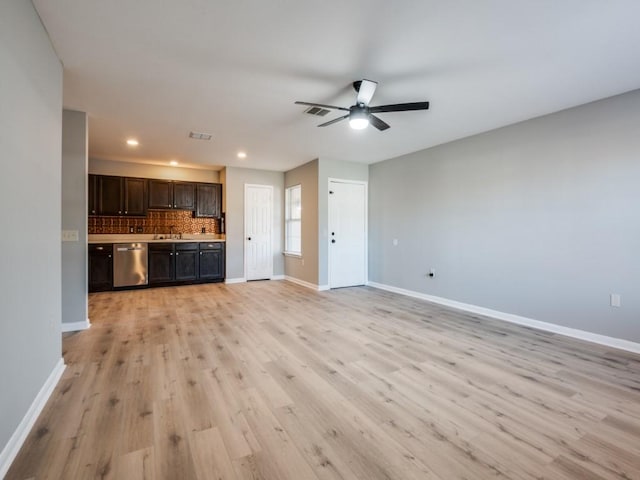 unfurnished living room with sink, light hardwood / wood-style flooring, and ceiling fan