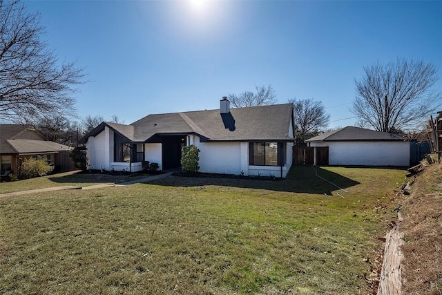 ranch-style home with a front lawn