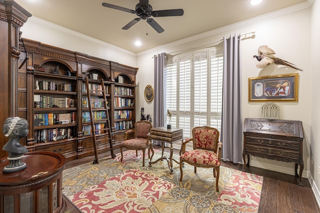 sitting room with crown molding, dark hardwood / wood-style floors, and ceiling fan