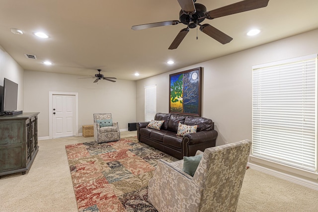 carpeted living room featuring ceiling fan