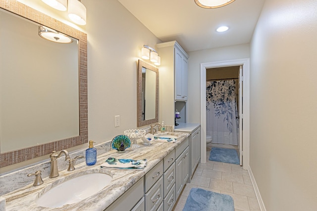 bathroom featuring tile patterned floors, vanity, and toilet