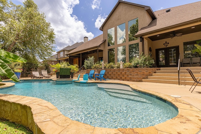 view of pool with a patio, ceiling fan, and french doors