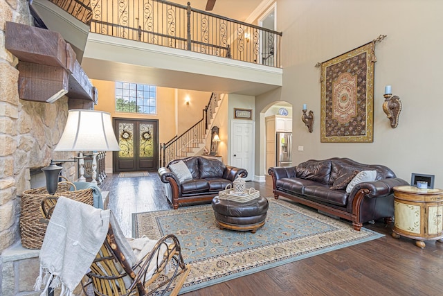 living room with a high ceiling and wood-type flooring