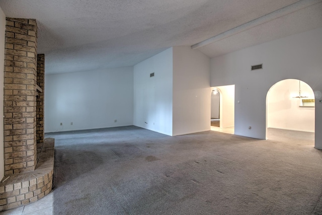 carpeted empty room featuring beamed ceiling, high vaulted ceiling, and a textured ceiling