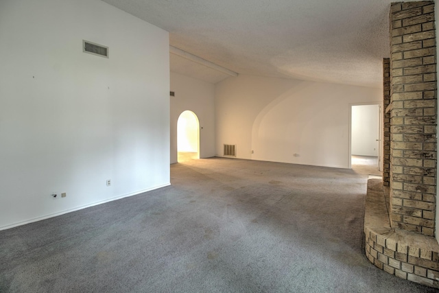 empty room with vaulted ceiling with beams, carpet floors, and a textured ceiling