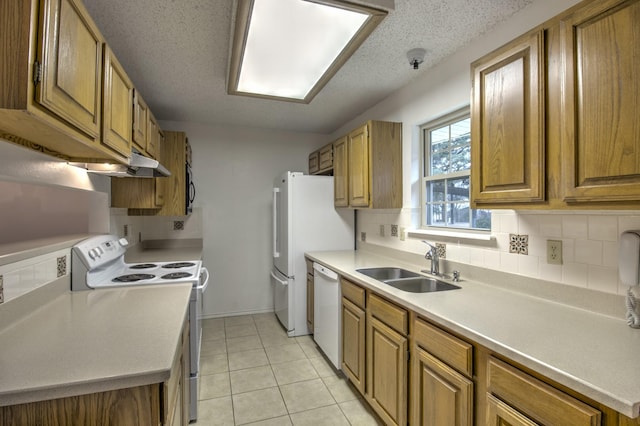 kitchen with sink, white appliances, backsplash, a textured ceiling, and light tile patterned flooring