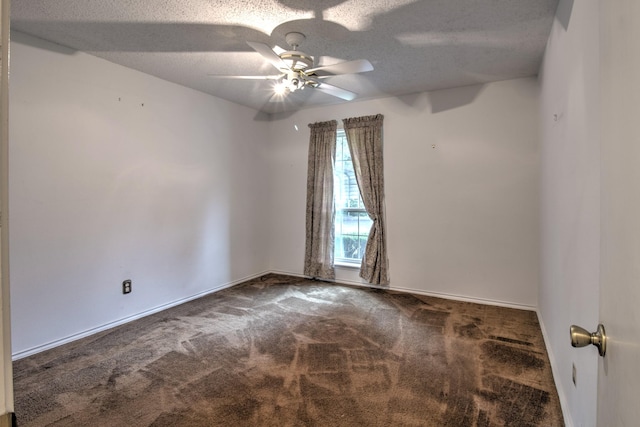 carpeted spare room with ceiling fan and a textured ceiling