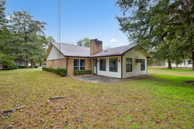 back of property with a lawn and a patio