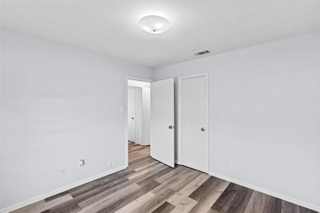 unfurnished bedroom with wood-type flooring