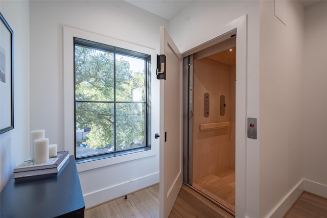 bathroom with wood-type flooring and elevator