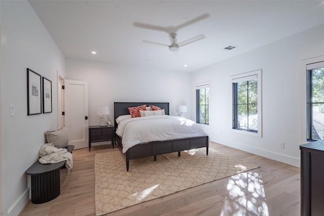 bedroom with ceiling fan and light wood-type flooring