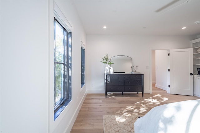 bedroom with multiple windows, ceiling fan, and light hardwood / wood-style flooring