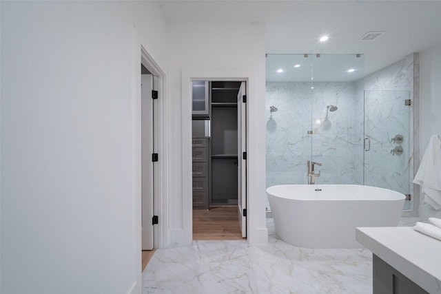 bathroom with independent shower and bath and vanity