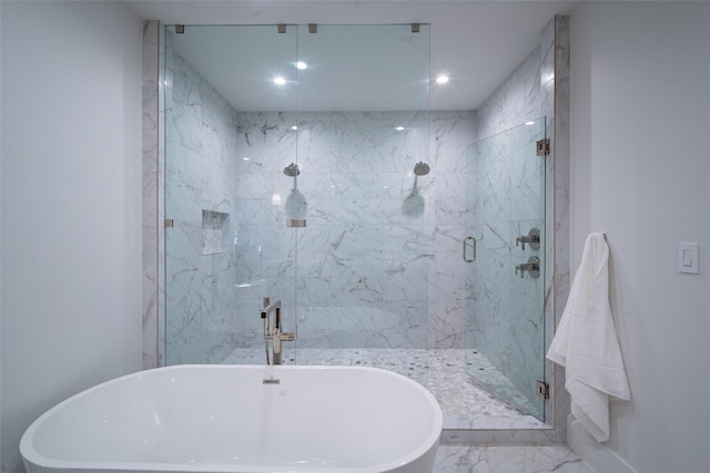 bathroom featuring shower with separate bathtub