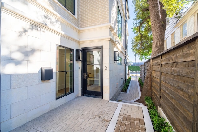 property entrance featuring a patio area