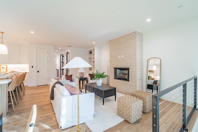 living room featuring a fireplace and light hardwood / wood-style flooring