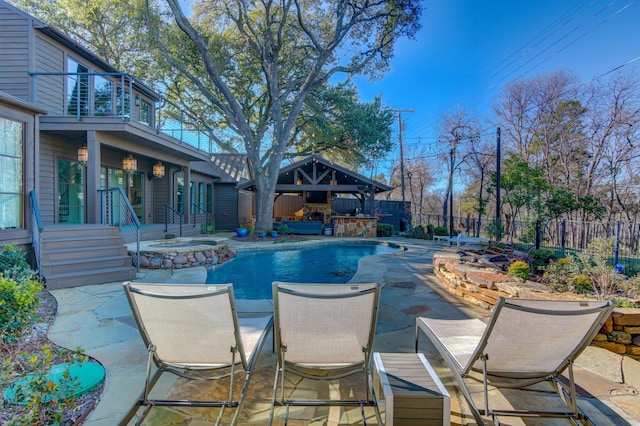 view of swimming pool with an in ground hot tub, a patio area, and a gazebo