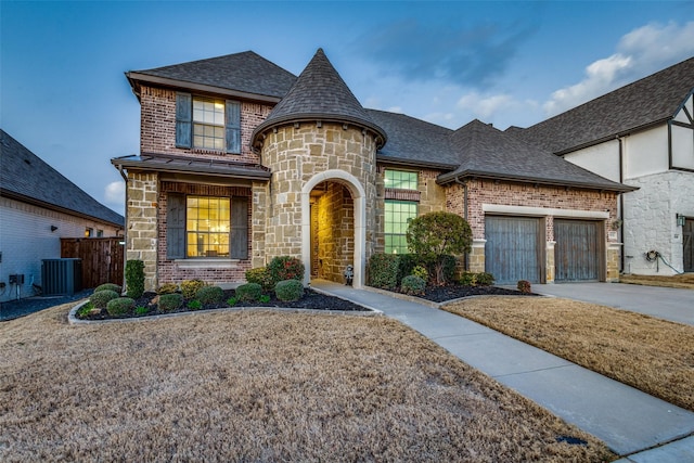 view of front of home with central AC and a garage