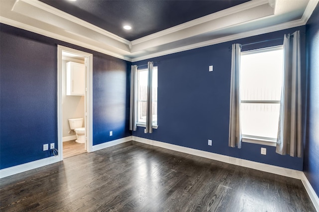 empty room featuring hardwood / wood-style flooring, crown molding, and a tray ceiling