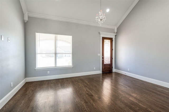 foyer with crown molding, a wealth of natural light, and an inviting chandelier